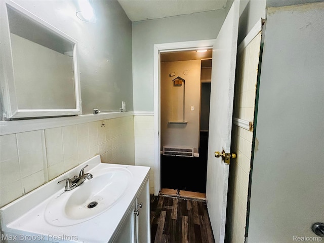 22510 Frisbee St, Detroit, MI 48219 - bathroom with tile walls, wood finished floors, vanity, and a wainscoted wall