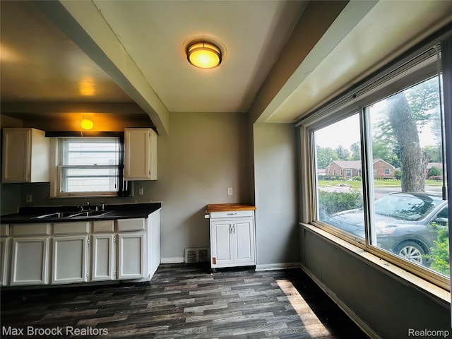 22510 Frisbee St, Detroit, MI 48219 - kitchen featuring dark wood-style floors, dark countertops, and white cabinets