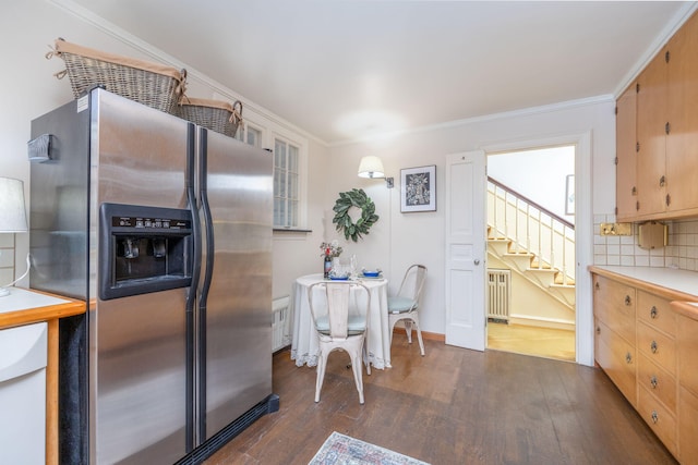 106 Rust Ave, Big Rapids, MI 49307 - kitchen with stainless steel fridge with ice dispenser, dark wood-style flooring, light countertops, crown molding, and radiator