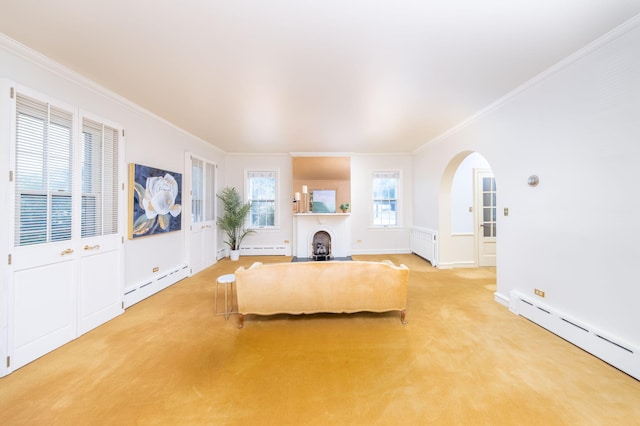 106 Rust Ave, Big Rapids, MI 49307 - living area featuring a baseboard heating unit, crown molding, arched walkways, and light carpet
