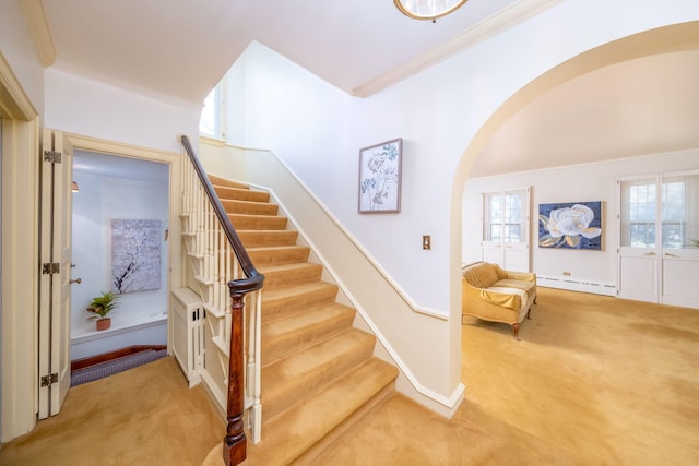 106 Rust Ave, Big Rapids, MI 49307 - staircase with carpet floors, a baseboard radiator, arched walkways, and ornamental molding