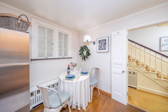 106 Rust Ave, Big Rapids, MI 49307 - dining room featuring stairs, wood finished floors, and ornamental molding