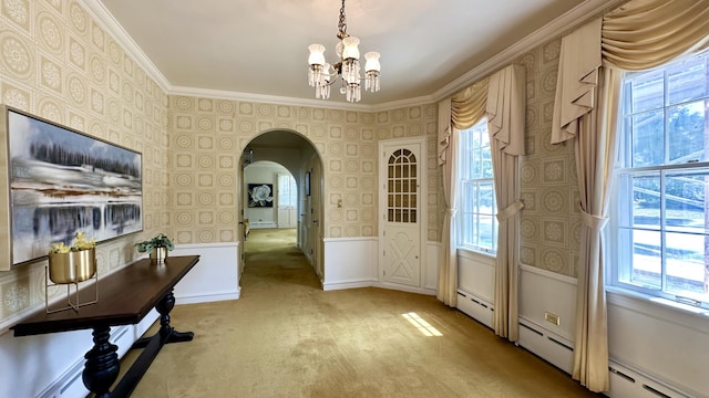 106 Rust Ave, Big Rapids, MI 49307 - foyer entrance featuring wallpapered walls, arched walkways, a chandelier, light colored carpet, and crown molding