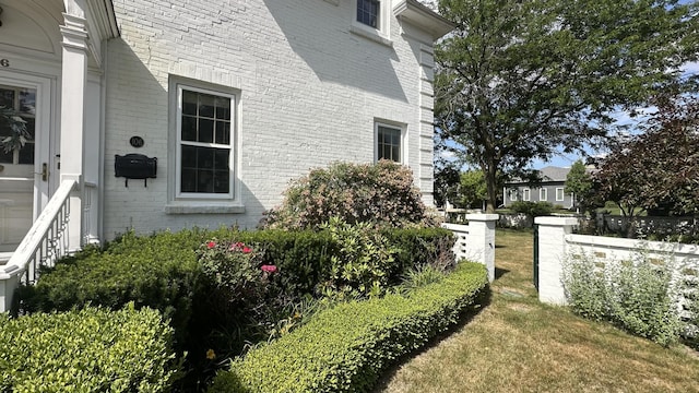 106 Rust Ave, Big Rapids, MI 49307 - view of property exterior with brick siding and a lawn