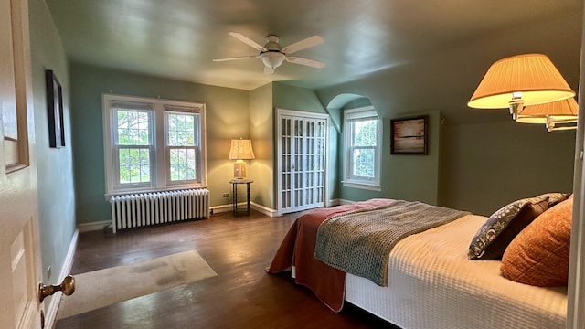 106 Rust Ave, Big Rapids, MI 49307 - bedroom with radiator, wood finished floors, ceiling fan, and arched walkways