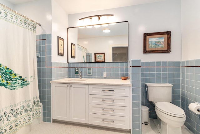 2659 Bedford Rd, Ann Arbor, MI 48104 - full bathroom with tile walls, vanity, tile patterned floors, a shower with shower curtain, and wainscoting