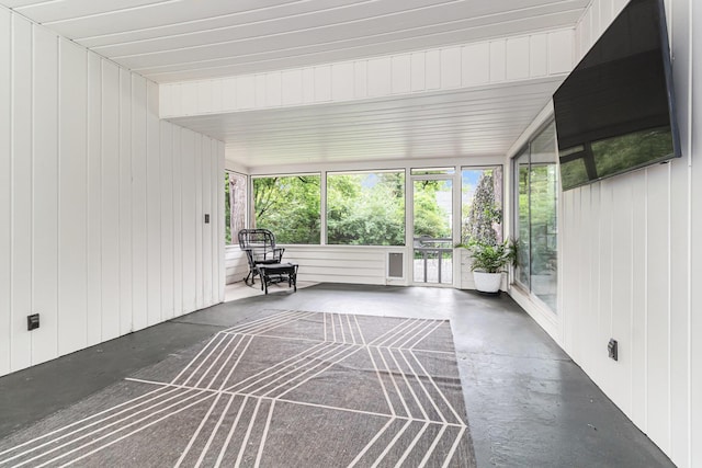 2659 Bedford Rd, Ann Arbor, MI 48104 - unfurnished sunroom featuring concrete flooring, healthy amount of natural light, and wooden walls