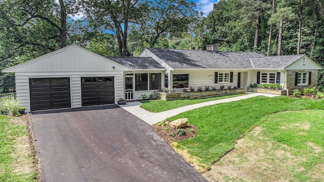 2659 Bedford Rd, Ann Arbor, MI 48104 - single story home featuring driveway, a front yard, an attached garage, a chimney, and view of scattered trees