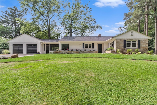 2659 Bedford Rd, Ann Arbor, MI 48104 - ranch-style home with a garage, driveway, a front yard, and stone siding
