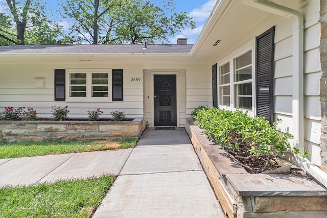 2659 Bedford Rd, Ann Arbor, MI 48104 - doorway to property featuring a chimney and covered porch