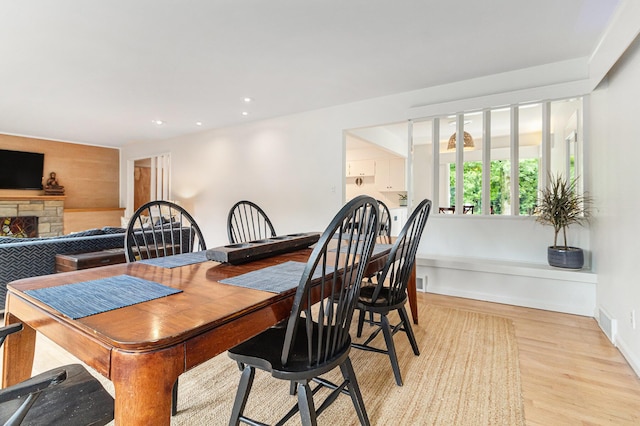 2659 Bedford Rd, Ann Arbor, MI 48104 - dining room featuring light wood-type flooring, a fireplace, and recessed lighting