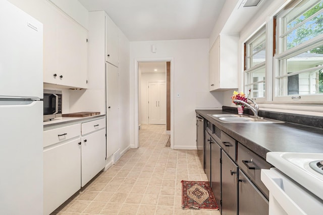 2659 Bedford Rd, Ann Arbor, MI 48104 - kitchen featuring appliances with stainless steel finishes, white cabinetry, and dark countertops