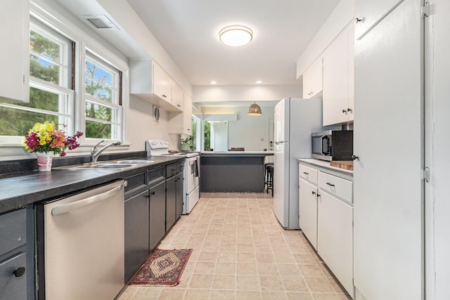2659 Bedford Rd, Ann Arbor, MI 48104 - kitchen with stainless steel appliances, white cabinets, and recessed lighting