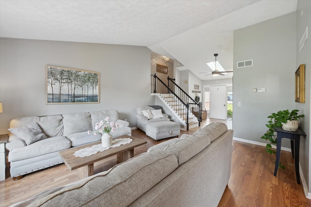 1393 Shankin Dr, Walled Lake, MI 48390 - living area with stairway, wood finished floors, vaulted ceiling, and a ceiling fan