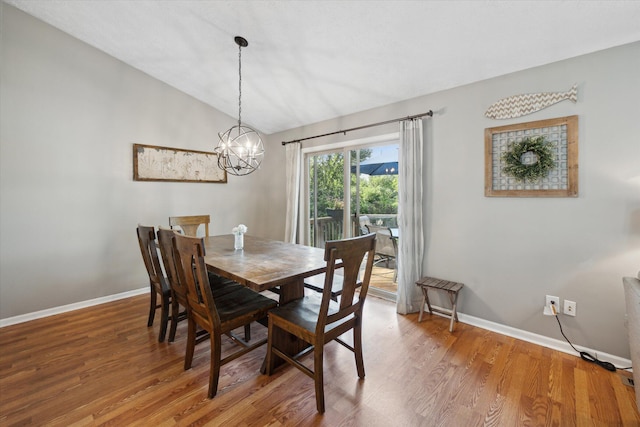 1393 Shankin Dr, Walled Lake, MI 48390 - dining room featuring a chandelier, vaulted ceiling, and wood finished floors