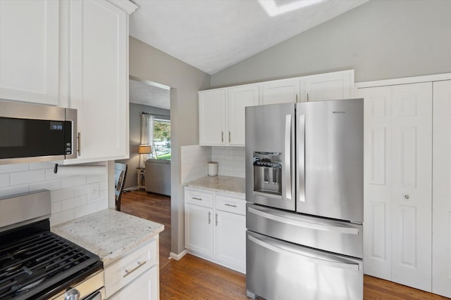 1393 Shankin Dr, Walled Lake, MI 48390 - kitchen with appliances with stainless steel finishes, backsplash, vaulted ceiling, dark wood-style flooring, and white cabinets