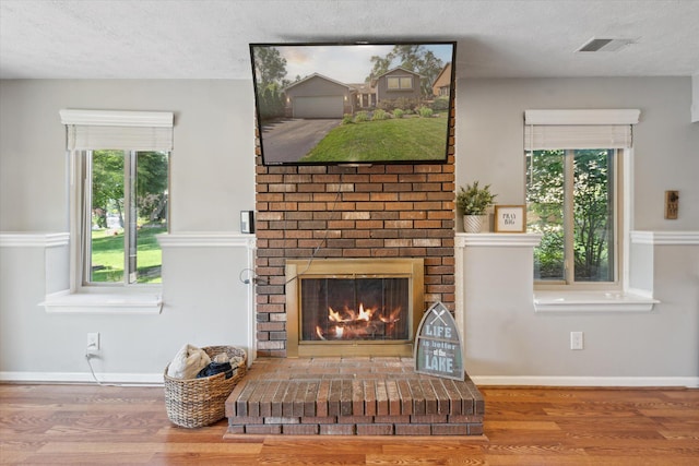 1393 Shankin Dr, Walled Lake, MI 48390 - living room featuring wood finished floors, a fireplace, and a textured ceiling