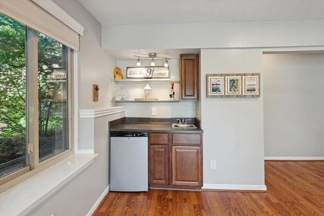 1393 Shankin Dr, Walled Lake, MI 48390 - indoor wet bar featuring dishwashing machine and dark wood-style flooring