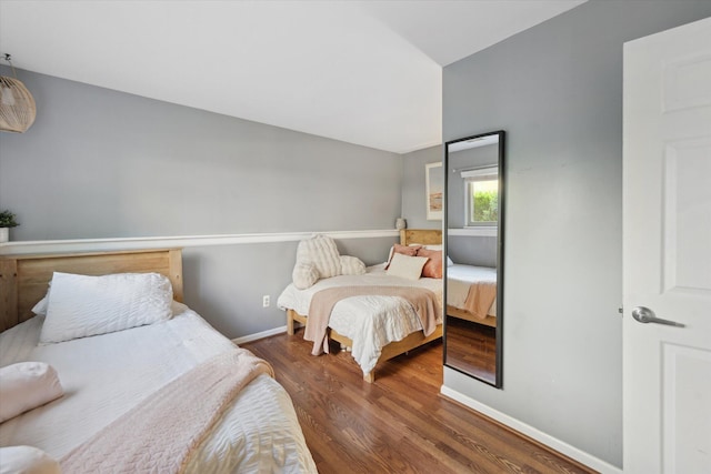 1393 Shankin Dr, Walled Lake, MI 48390 - bedroom featuring wood finished floors and vaulted ceiling