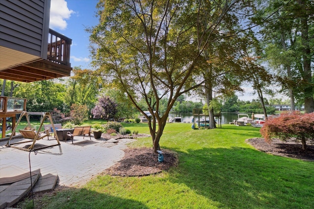 1393 Shankin Dr, Walled Lake, MI 48390 - view of grassy yard with a water view and a patio area
