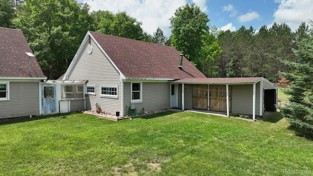 3733 N Hoover Ave, Gladwin, MI 48624 - back of property with a lawn and roof with shingles