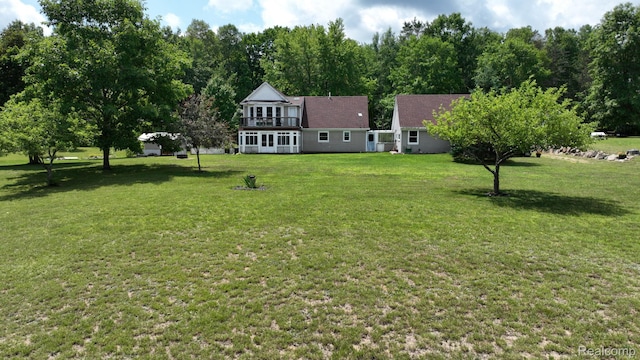 3733 N Hoover Ave, Gladwin, MI 48624 - view of green lawn featuring a balcony