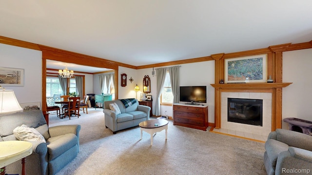 3733 N Hoover Ave, Gladwin, MI 48624 - living area featuring light carpet, a chandelier, a tiled fireplace, and crown molding