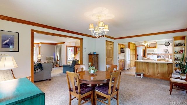 3733 N Hoover Ave, Gladwin, MI 48624 - dining space featuring light colored carpet, a chandelier, ornamental molding, and ceiling fan