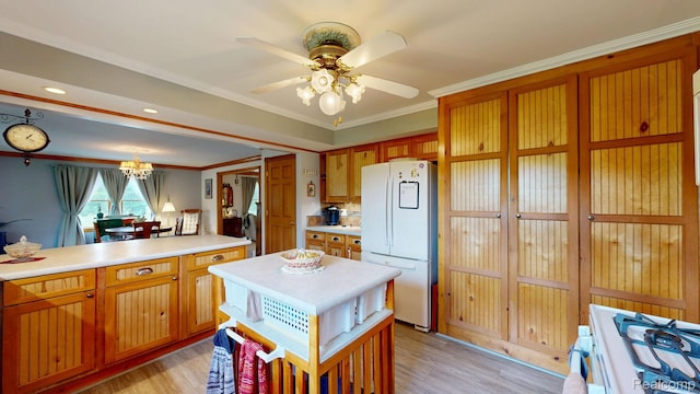 3733 N Hoover Ave, Gladwin, MI 48624 - kitchen featuring freestanding refrigerator, light countertops, light wood-style flooring, range, and crown molding