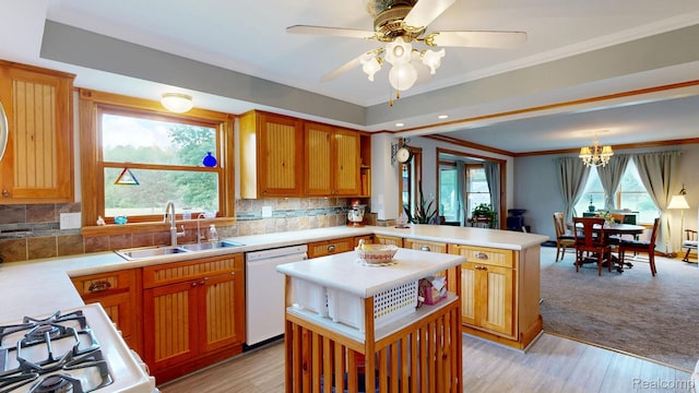 3733 N Hoover Ave, Gladwin, MI 48624 - kitchen featuring white dishwasher, a peninsula, light countertops, ornamental molding, and tasteful backsplash