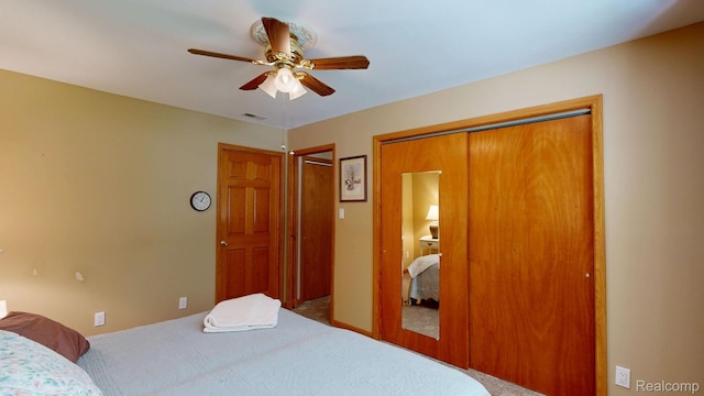 3733 N Hoover Ave, Gladwin, MI 48624 - bedroom featuring carpet flooring, ceiling fan, and multiple closets