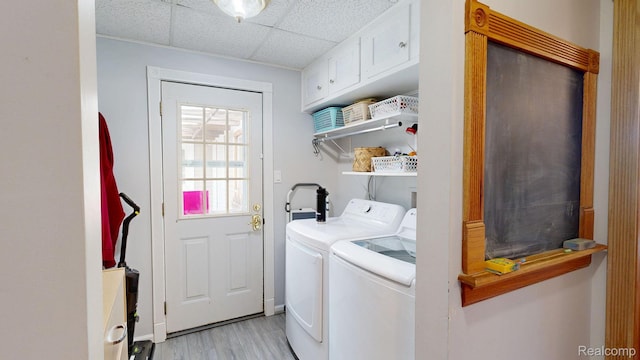 3733 N Hoover Ave, Gladwin, MI 48624 - washroom with cabinet space, washer and dryer, and light wood-type flooring