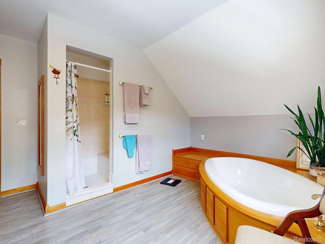 3733 N Hoover Ave, Gladwin, MI 48624 - full bath featuring a shower stall, a bath, wood finished floors, and lofted ceiling