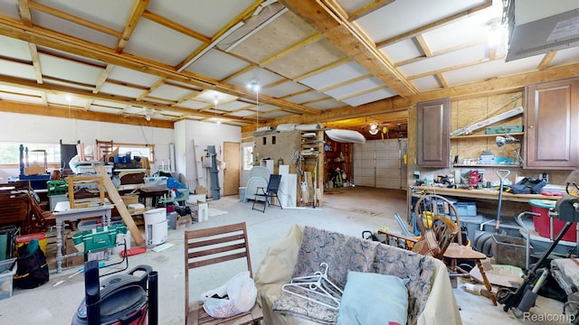 3733 N Hoover Ave, Gladwin, MI 48624 - misc room with a workshop area, a garage, and concrete floors