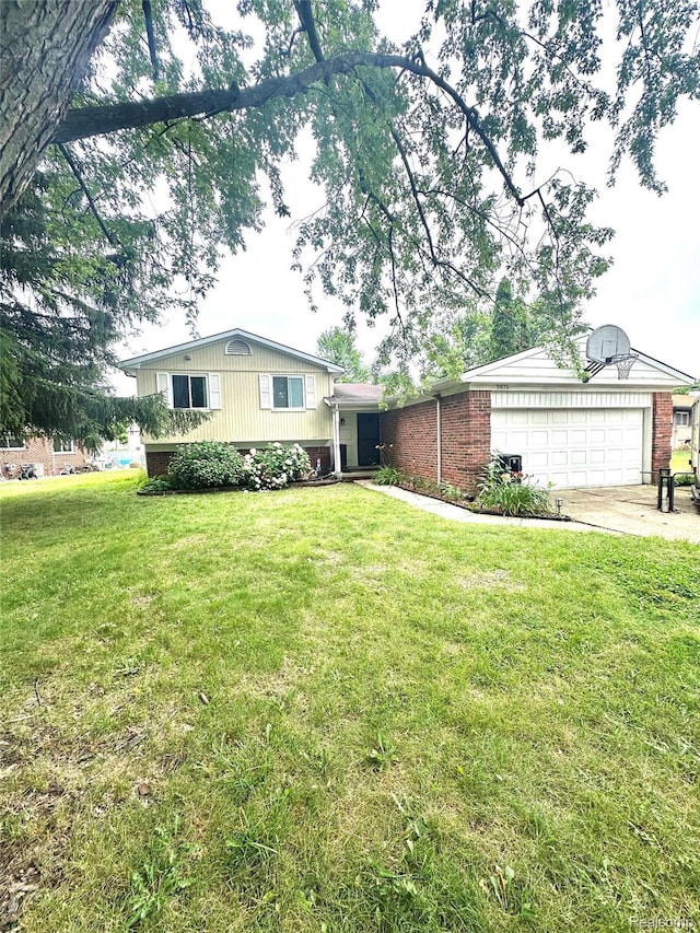 5076 Spring Well Ln, Grand Blanc, MI 48439 - tri-level home featuring a front lawn, concrete driveway, an attached garage, and brick siding
