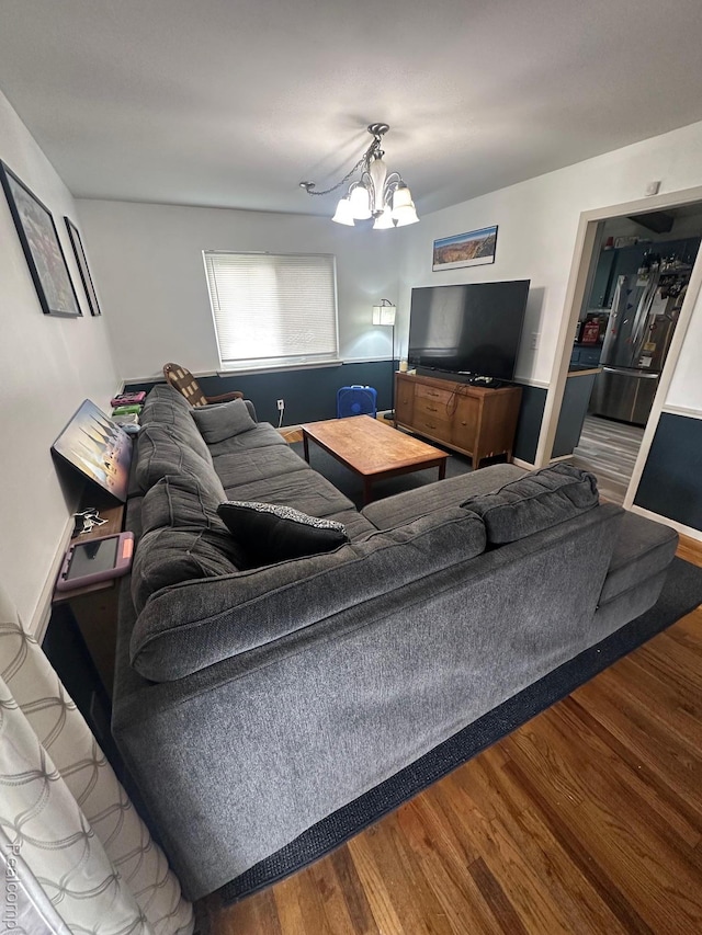 5076 Spring Well Ln, Grand Blanc, MI 48439 - living area featuring wood finished floors and a chandelier