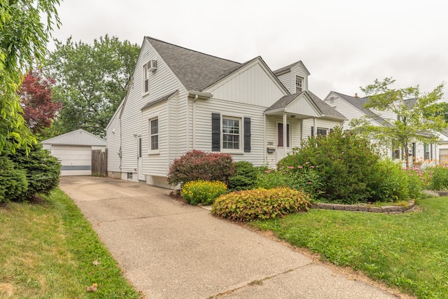 2100 Alice St, Ann Arbor, MI 48103 - view of front of home with an outbuilding, a detached garage, roof with shingles, and a front yard