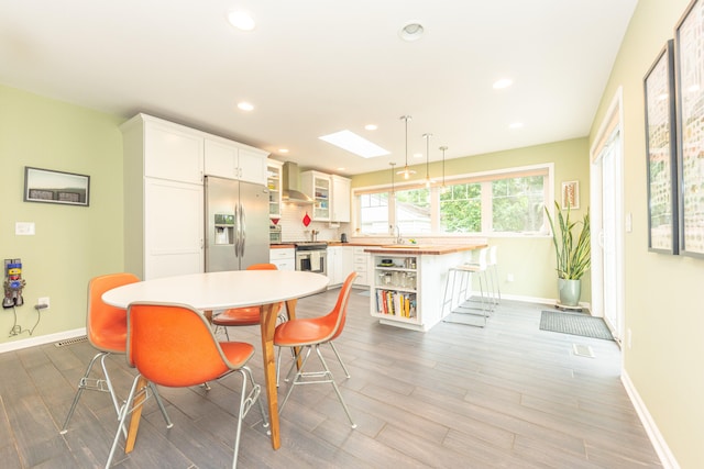 2100 Alice St, Ann Arbor, MI 48103 - dining room featuring recessed lighting, wood finished floors, and a skylight