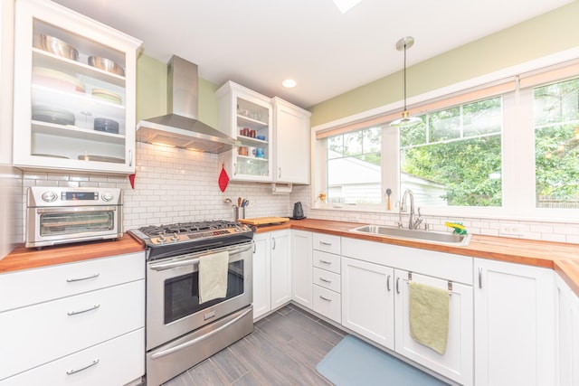 2100 Alice St, Ann Arbor, MI 48103 - kitchen with wooden counters, stainless steel range with gas stovetop, and wall chimney exhaust hood