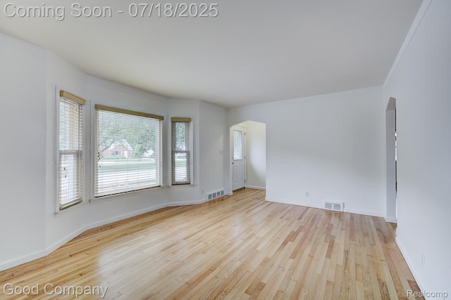 923 E 4th St, Royal Oak, MI 48067 - empty room featuring hardwood / wood-style flooring, arched walkways, and ornamental molding