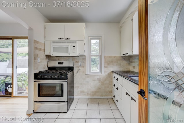 923 E 4th St, Royal Oak, MI 48067 - kitchen featuring white microwave, stainless steel gas stove, white cabinets, and light tile patterned floors