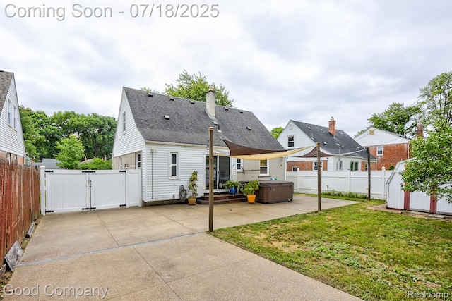 923 E 4th St, Royal Oak, MI 48067 - rear view of house with a patio area, a hot tub, a gate, a fenced backyard, and a storage unit