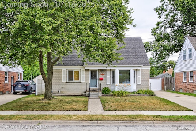 923 E 4th St, Royal Oak, MI 48067 - view of front of home with brick siding, concrete driveway, and roof with shingles