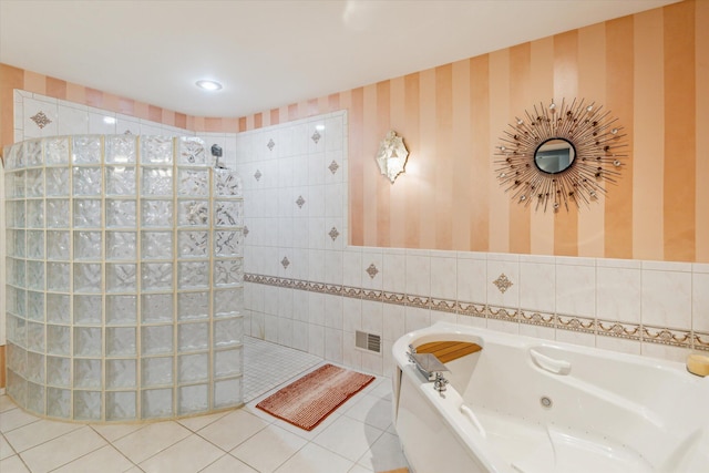 11 Geiger Ave, Battle Creek, MI 49037 - full bathroom featuring a tub with jets, walk in shower, tile patterned flooring, wallpapered walls, and tile walls