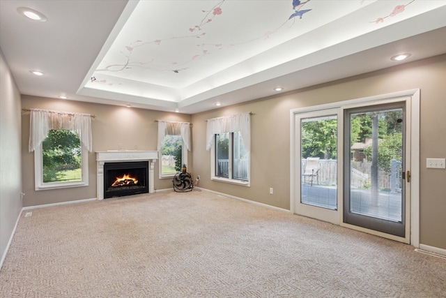 11 Geiger Ave, Battle Creek, MI 49037 - unfurnished living room featuring carpet flooring, healthy amount of natural light, recessed lighting, and a lit fireplace