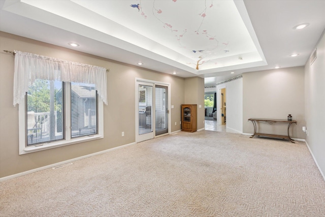 11 Geiger Ave, Battle Creek, MI 49037 - unfurnished living room with carpet floors, recessed lighting, and a tray ceiling