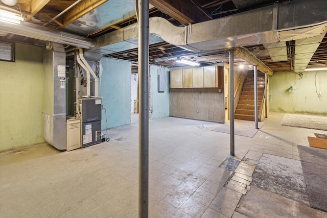 11 Geiger Ave, Battle Creek, MI 49037 - unfinished below grade area with stairway, heating unit, tile patterned floors, and electric panel