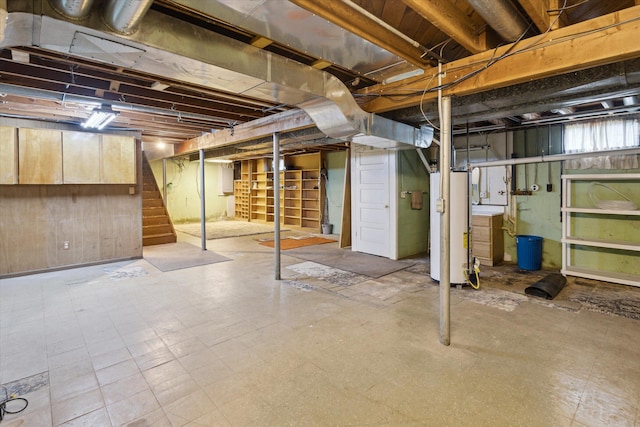 11 Geiger Ave, Battle Creek, MI 49037 - below grade area with stairs, gas water heater, tile patterned floors, and wood walls