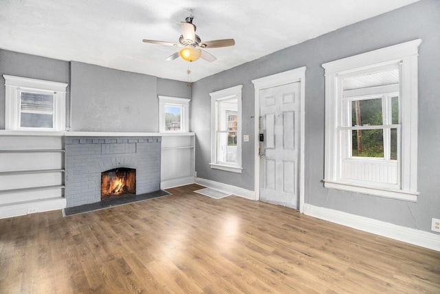 1850 S Burdick St, Kalamazoo, MI 49001 - unfurnished living room with ceiling fan, wood finished floors, and a fireplace