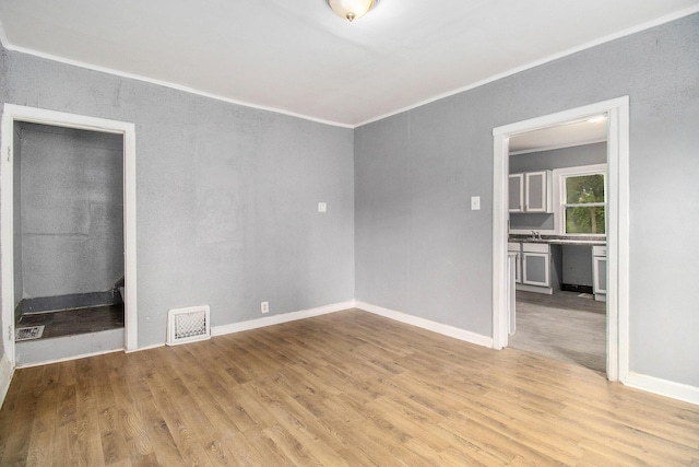 1850 S Burdick St, Kalamazoo, MI 49001 - spare room featuring ornamental molding and light wood finished floors
